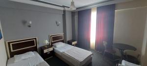 a hotel room with two beds and a table and a window at AQUA MARMARA LİFE Hotel in Marmaraereglisi