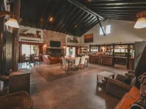 a large living room with a table and chairs at El Madejo - del Valle de Uco in Tunuyán