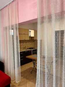 a room with curtains in a kitchen with a table at Hotel PEJA in Velipojë +114 photos