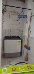 a small kitchen with a stove and a broom at Casa SAYBER DON DIEGO in Don Diego