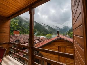 a view from the balcony of a cabin with a mountain view at CERRAHPAŞA SUİTE HOTEL in Uzungöl