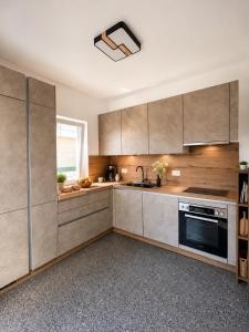 a kitchen with stainless steel appliances and a window at Villa Tadini JOY in Babići