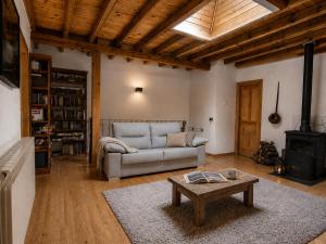 a living room with a couch and a table at El Palacito de Villoslada in Villoslada de Cameros