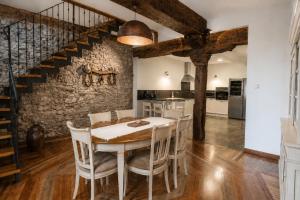 a kitchen and dining room with a table and chairs at El Palacito de Villoslada in Villoslada de Cameros