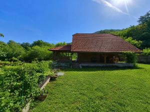 a small house in a yard with a green field at Villa Felix with spectacular pool in green oasis in Opatija