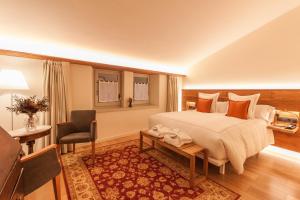 a bedroom with a bed and a desk and a chair at Hotel Finca Llongarriu - Only Adults in Vall de Bianya +84 photos