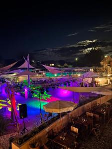 a pool at night with purple and green lights at Casa Diu in Avrig