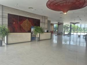 a lobby with potted plants in a building at Arena Lucky Condotel in Cam Ranh International Airport +25 photos