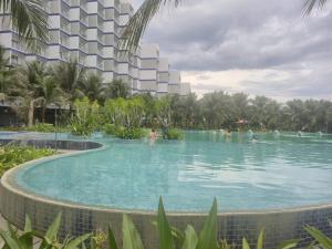 a swimming pool in the middle of a resort at Arena Lucky Condotel in Cam Ranh International Airport