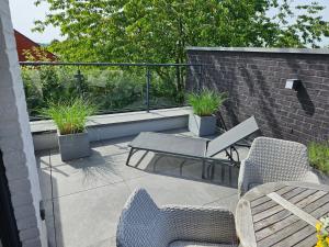 a patio with chairs and a table and a balcony at Casa 47 in Eupen
