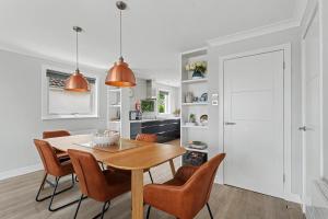 a kitchen and dining room with a table and chairs at Stylish 3 Bedroom with Balcony and Amazing View in Dollar