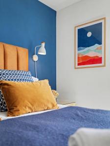 a blue bedroom with a bed and a lamp at Stylish 3 Bedroom with Balcony and Amazing View in Dollar