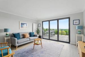 a living room with a couch and a table at Stylish 3 Bedroom with Balcony and Amazing View in Dollar