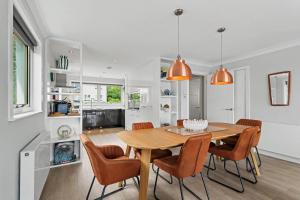 a kitchen and dining room with a wooden table and chairs at Stylish 3 Bedroom with Balcony and Amazing View in Dollar