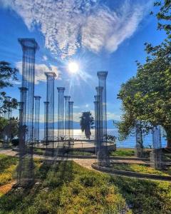a view of the ocean through a metal fence at La Roccia in Reggio di Calabria