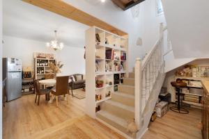 a staircase in a home with a dining room and a kitchen at Bed and Breakfast Al Vecio Morer in San Donà di Piave