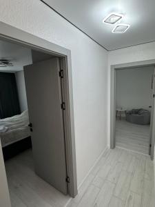 an empty room with a door leading to a bedroom at Premium 2-Room Rental in Bălţi