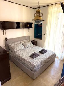 a bedroom with a bed with two towels on it at Le Statuine Dimore Diffuse in Barletta +62 photos