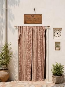 ajar door with a sign on top of it at The Heritage Eco Stay in Bikaner