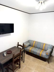 a living room with a couch and a table at Le Statuine Dimore Diffuse in Barletta