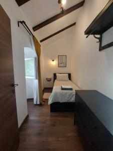 a bedroom with two beds in a room with a window at House Belej - Lola in Belej