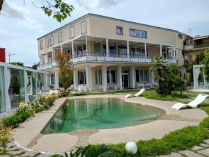 a house with a swimming pool in front of it at Hotel Elio in Marigliano