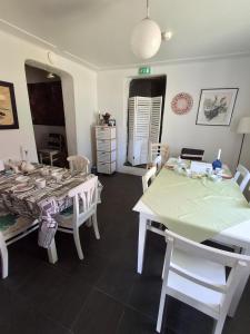 a white dining room with a table and chairs at Lossiranta Tavis in Savonlinna