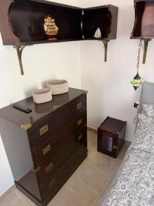 a bedroom with a dresser and a bed at Le Statuine Dimore Diffuse in Barletta