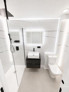 a bathroom with a sink and a toilet at ApartamentosCRP in Almería +27 photos