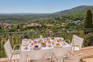 a table with food on a balcony with a view at Château Saint-Martin & Spa, Oetker Hotels in Vence