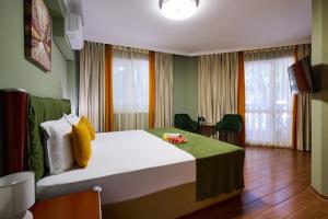 a hotel room with a large bed in a room at Art Green Boutique Hotel in Varna City