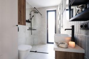 a bathroom with a toilet and a sink with a candle at Osada Znamirowice in Znamirowice