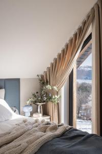 a bedroom with a bed and a window at Osada Znamirowice in Znamirowice