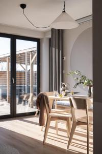 a dining room with a wooden table and chairs at Osada Znamirowice in Znamirowice +24 photos