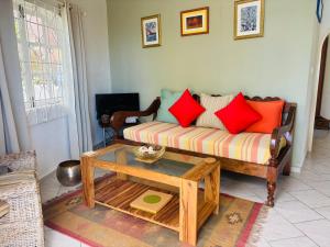 a living room with a couch and a coffee table at Epea Ocean View Top in Victoria