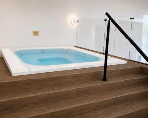 a jacuzzi tub in a room with stairs at The Wiltshire Hotel, Golf and Leisure Resort in Swindon