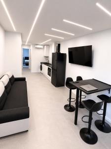 a living room with a couch and a table at ApartamentosCRP in Almería