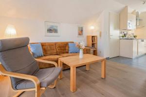 a living room with a couch and a table at Ferienanlage Seeblick Aquamarin in Koserow