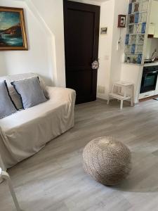 a living room with a couch and a wooden floor at Appartamento La Fontina in Marciana Marina
