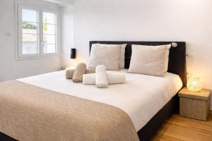 a bedroom with a large bed with white sheets and a window at Les Arches d'Or - Loft 200 m2 avec Rooftop, Jacuzzi et 3 Suites - Centre 5 min - Proche A7-A9 in Orange +45 photos