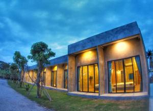 a building with windows on the side of it at Alinda Resort in Phetchaburi