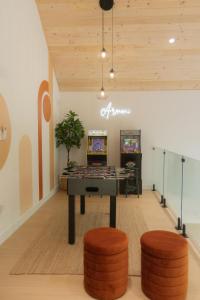 a room with a ping pong table and two stools at Armoni Ski & Spa in Cantley
