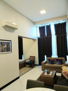 a living room with a couch and a table at Mactan Newtown Condo Rentals in Punta Engaño