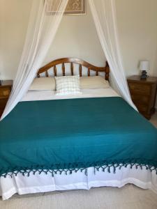 a bedroom with a bed with a canopy at Epea Ocean View Top in Victoria