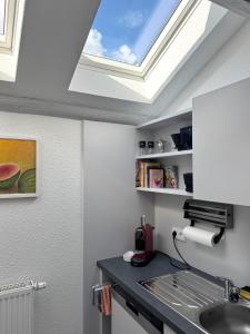 a skylight in a kitchen with a sink at Brauhaus Suite 16 in Sebnitz