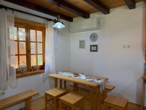 a room with a table and some chairs and a window at Zov Dičine in Savinac