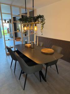 a dining table and chairs in a room at House for Tomorrowland in Rijweg