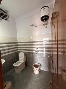 a bathroom with a toilet and a sink at Forest Breeze Homestay in Kanatal