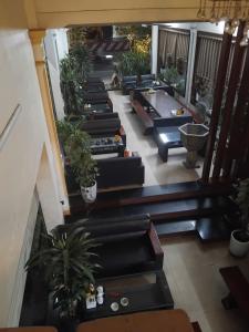 a staircase with black couches and potted plants at PHƯƠNG LƯU Hotel in Văn Lâm