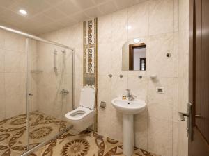 a bathroom with a toilet and a sink and a shower at CERRAHPAŞA SUİTE HOTEL in Uzungöl +68 photos